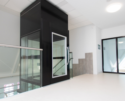platform lift installed in a commercial building providing wheelchair accessibility between levels