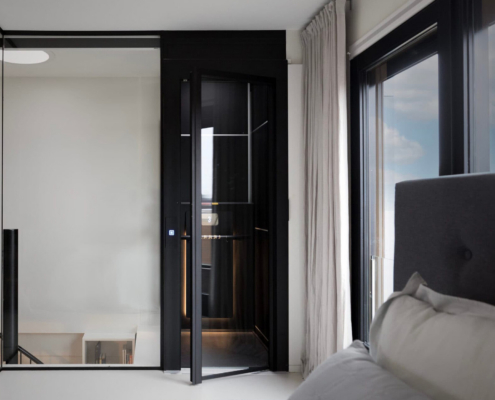 Front View Of Cibes Air Residential Elevator Near Bed